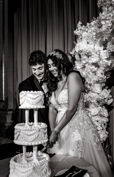 Bride and groom cutting a three-tier vintage wedding cake